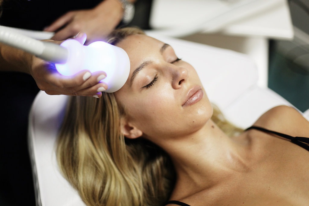 Cryo Facial cooling treatment applied across a guest's forehead