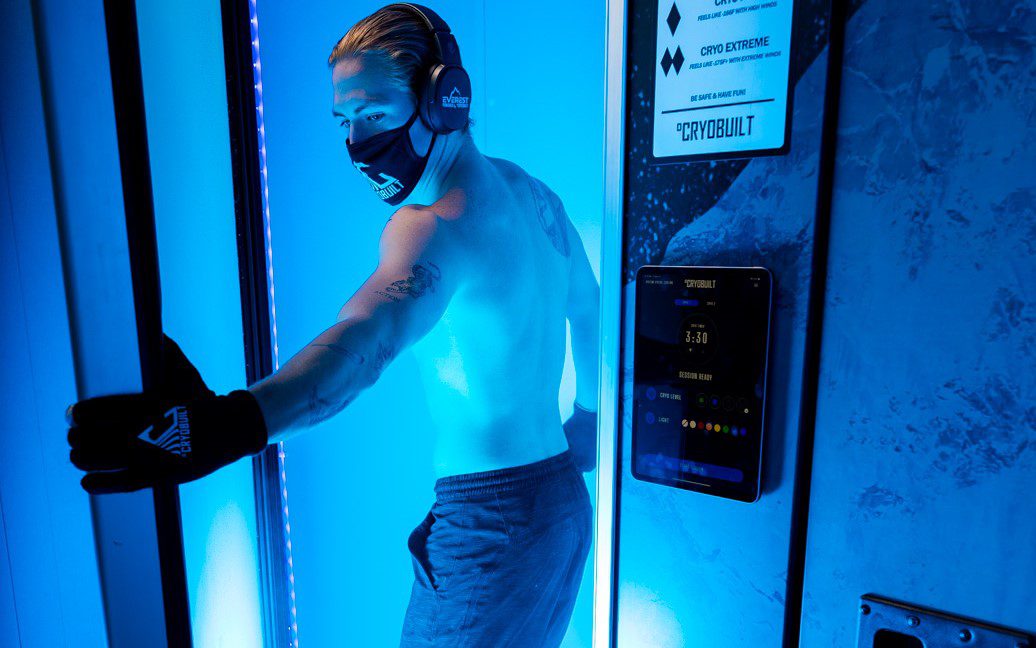 Man enjoying whole body cryotherapy session with headphones in Palm Harbor