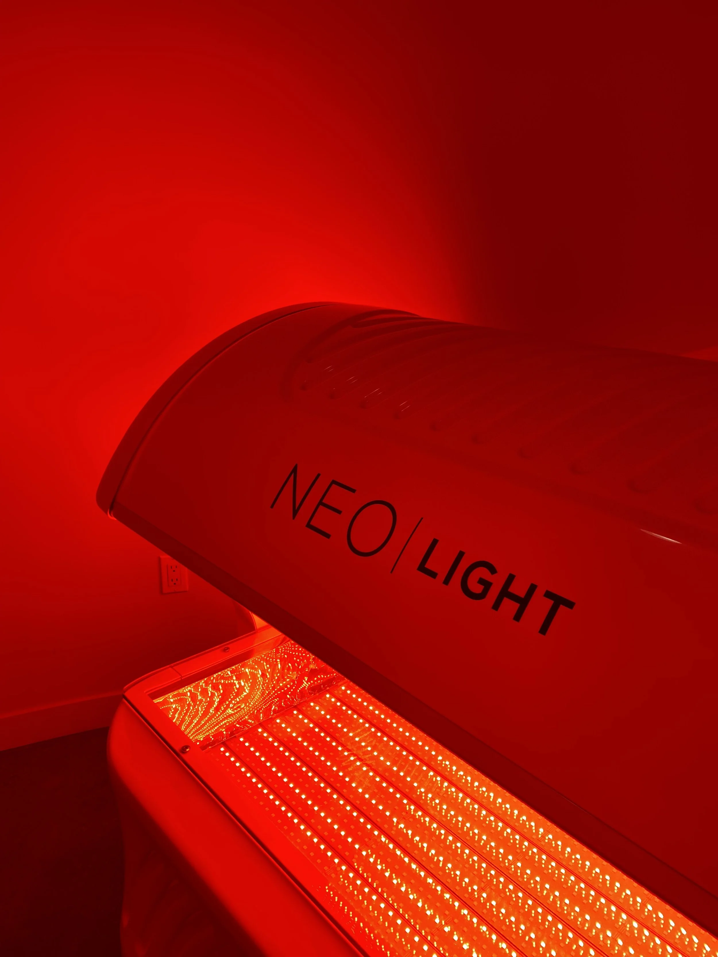 NEO LIGHT red light therapy bed close-up showing LED panels